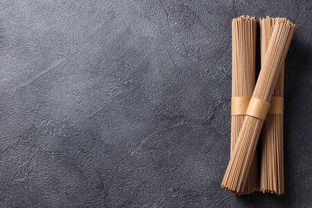 Noodles soba on slate background. Traditional Japanese food. Top view. Copy space.