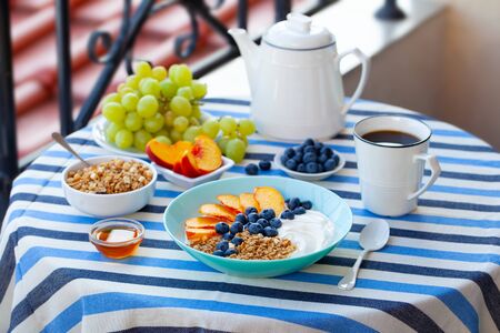 Healthy breakfast with coffee served on table. Outdoor background.の写真素材