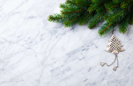 Christmas and New Year decoration, fir tree and ornaments. Marble background. Copy space. Top view.の写真素材