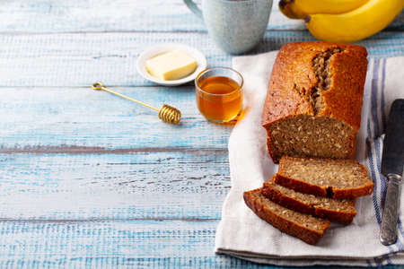 Healthy vegan oat and banana loaf bread, cake. Blue wooden background. Copy space.