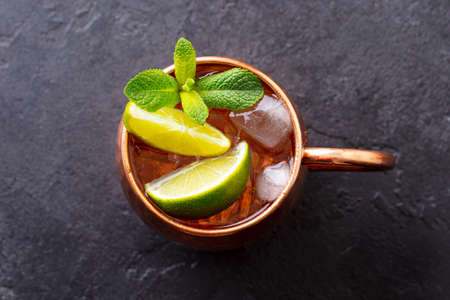 Moscow Mules cocktail with ginger beer, vodka, lime and mint. Grey background. Close up. Top view.の写真素材