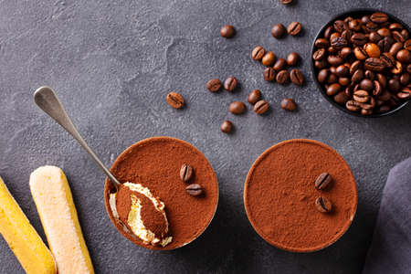 Tiramisu dessert in glasses. Dark grey background. Top view.の写真素材