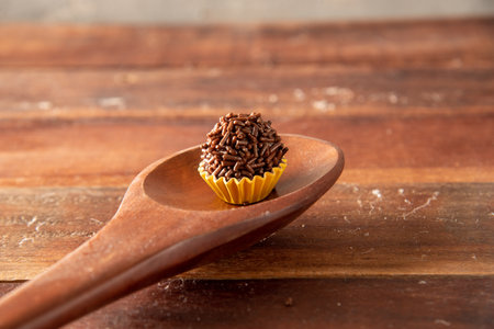 Brigadeiro (Brigadeiro) Traditional Brazilian sweet. Lined up on a wooden board.