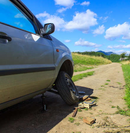 Machine with a flat tire is on a country roadの写真素材