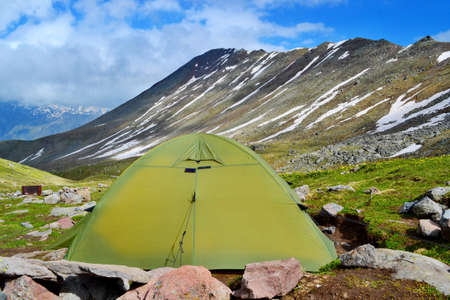 Sleeping in the tent below the Kazbek Mountain above the small city of Stepantsminda. Sunny day, beautiful views.の写真素材