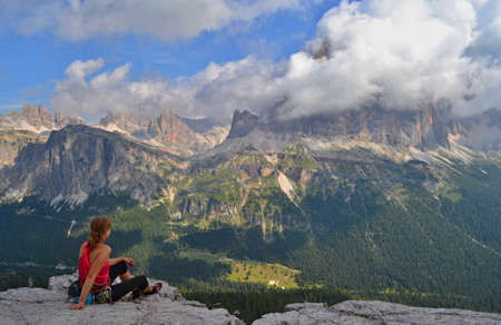 Climber is sitting on top of Cinque Terre tower, enjoying beautiful view on Dolomites.の写真素材
