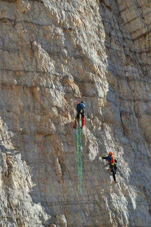 Climbers trying to reach the peak of Cima Piccola, Dolomites Mountains.の写真素材