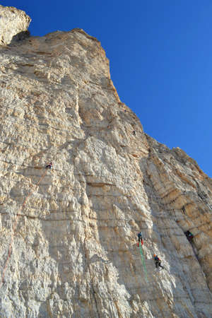 Climbers trying to reach the peak of Cima Piccola, Dolomites Mountains.の写真素材