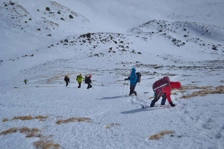 Tatra Mountains, Slovakia - FEBRUARY 23, 2019: A group of friends is climbing to the summit of Koprovsky Stit. Rising Through The Snow With Cats And Wands High In The Mountains.のeditorial素材