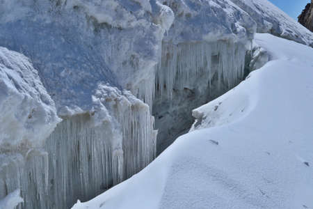 Cracked glacier with icicles. Gran Paradiso Massif. Climb to the summit of Gran Paradiso.