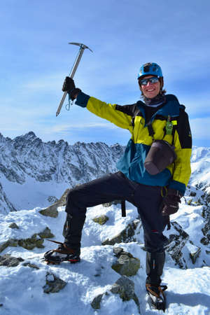 TATRA MOUNTAINS, SLOVAKIA - FEBRUARY 23, 2019: Young man standing at the summit of Koprovsky stit,...