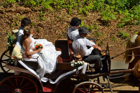 Valdstejn, Bohemian Paradise, Czech Republic - June 6, 2015: The bride and groom are leaving the wedding ceremony in a horse-drawn carriage. Beautiful sunny day.のeditorial素材