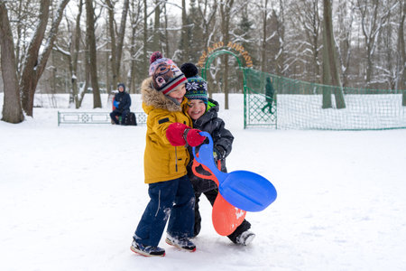 Two small boys are playing with snow. High quality photoの写真素材
