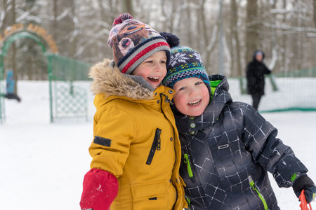Two small boys are playing with snow. High quality photoの写真素材