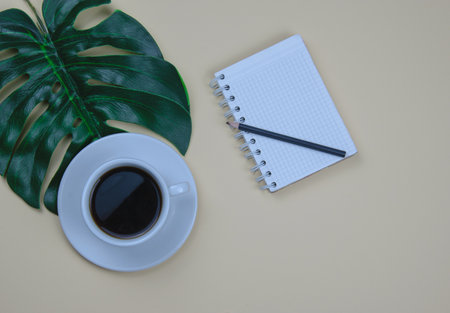 Aromatic black coffee in a white cup. A cup on a green leafの写真素材