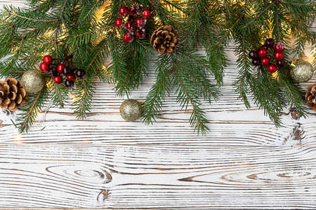 New Year background, Christmas card. Fir branches decorated with garlands, golden balls, pine cones...
