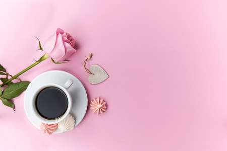 A white cup with fragrant black coffee on a pink backgroundの写真素材