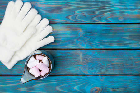 Cocoa with white and pink marshmallows in a blue mug