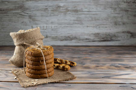 Oatmeal cookies stacked on a canvas napkinの写真素材