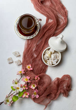 Aromatic hot tea in a Turkish cup on a light tableの写真素材