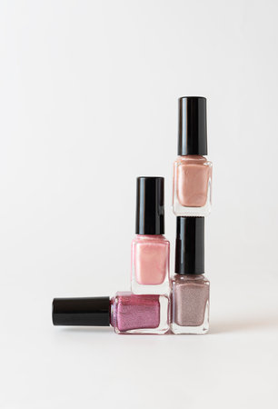 Nail polish of light shades of the pyramid stands on a white table. Isolates. white backgroundの写真素材