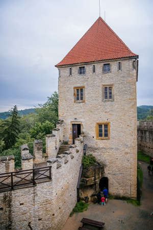 The medieval castle Kokorin with stone tower on a high hill in the green forest, Kokorin, Czech Republic. June 20, 2020のeditorial素材