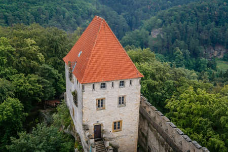 The medieval castle Kokorin with stone tower on a high hill in the green forest, Kokorin, Czech Republic. June 20, 2020のeditorial素材