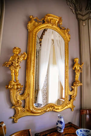 Luxury vintage mirror in gold frame. Interior of Castle Bitov, South Moravia Region, Czech Republic, July 05, 2020のeditorial素材