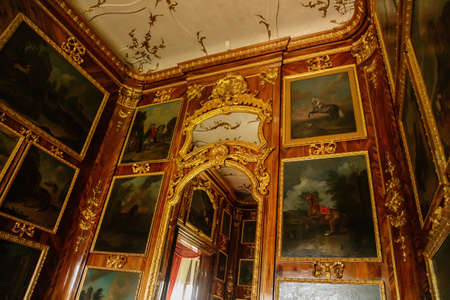 Castle interior. Wooden panels with paintings and gilded carvings. Milotice castle, South Moravia,...