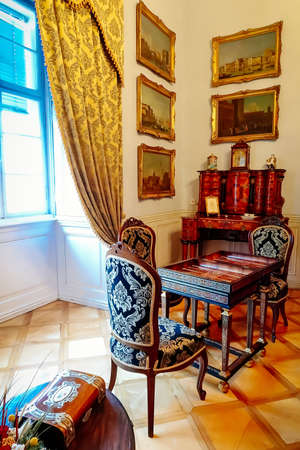 Castle interior. Antique carved furniture, table and chairs. Paintings on the walls. Renaissance...