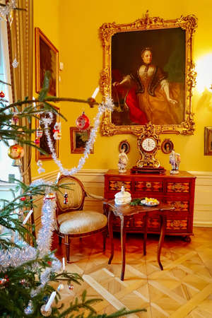 Castle interior. Antique carved furniture, table and chairs. Paintings on the walls. Renaissance castle Horsovsky Tyn, Czech Republic, December 31, 2018のeditorial素材