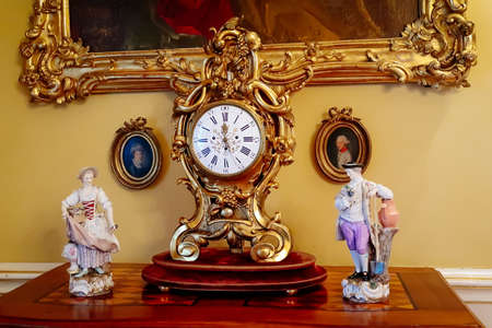 Castle interior. Porcelain figurines and antique clock. Renaissance castle Horsovsky Tyn, Czech Republic, December 31, 2018のeditorial素材