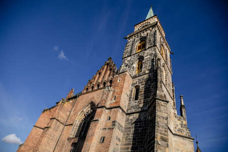 Medieval catholic church of Saint Jilji with gothic High clock tower in sunny autumn day, Nymburk, Central Bohemia, Czech Republic, November 17, 2020のeditorial素材