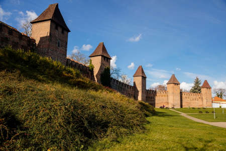Silhuette of town fortification with battlement and watch tower in sunny autumn day, medieval gothic wall and rampart, View from riverside, Nymburk, Central Bohemia, Czech Republic, November 17, 2020のeditorial素材