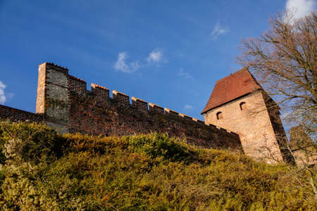 Silhuette of town fortification with battlement and watch tower in sunny autumn day, medieval gothic wall and rampart, View from riverside, Nymburk, Central Bohemia, Czech Republic, November 17, 2020のeditorial素材