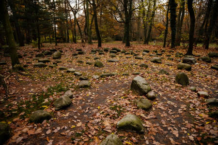 The entrance to spiral mystic oriental stone labyrinth in green garden, aesthetic symbol, Loucen romantic baroque castle, Czech republic, November 17, 2020のeditorial素材