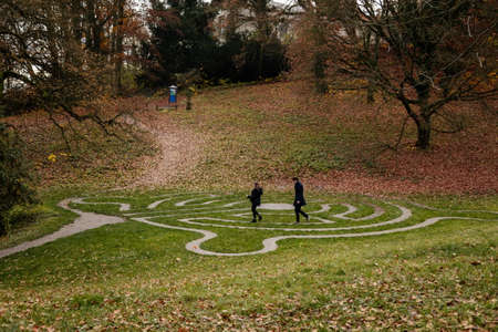 Stone pathway round outdoor prayer labyrinth in a circular shape, Ornamental garden with maze viewed...