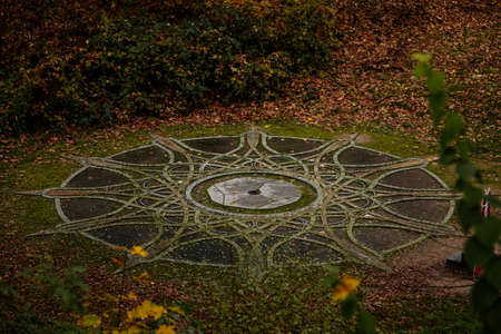 The entrance to spiral mystic oriental stone labyrinth in green garden, aesthetic symbol, Loucen romantic baroque castle, Czech republic, November 17, 2020のeditorial素材