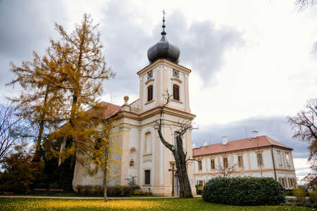 Loucen Rococo castle surrounded by a vast English park, Romantic baroque chateau with Church of the Assumption of the Virgin Mary in autumn day, Central Bohemia, Czech republic, November 22, 2020のeditorial素材