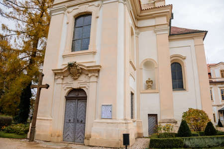 Loucen Rococo castle surrounded by a vast English park, Romantic baroque chateau with Church of the Assumption of the Virgin Mary in autumn day, Central Bohemia, Czech republic, November 22, 2020のeditorial素材