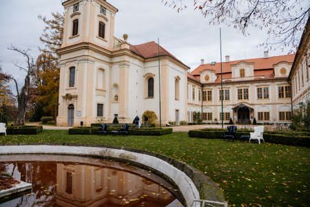 Loucen Rococo castle surrounded by a vast English park, Romantic baroque chateau with Church of the Assumption of the Virgin Mary in autumn day, Central Bohemia, Czech republic, November 22, 2020のeditorial素材