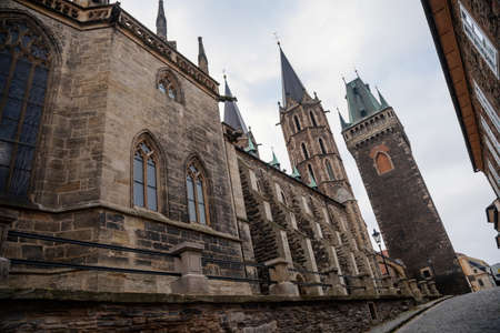 Medieval stone St. Bartholomew? S Church in autumn day, arched windows, chimeras and gargoyles,...