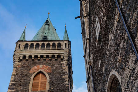 Medieval stone St. Bartholomew? S Church in autumn day, arched windows, chimeras and gargoyles,...