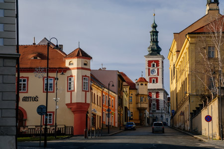 Narrow picturesque street with colorful buildings in old historic center of medieval royal town Slany, Old Town Hall with Clock Tower, Central Bohemia, Czech Republic, December 27, 2020のeditorial素材