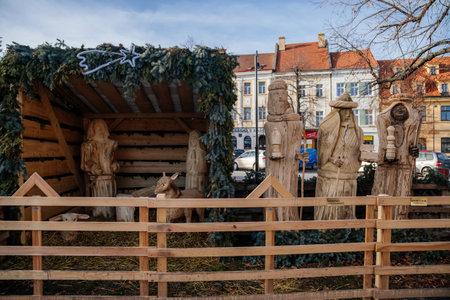 Christmas Nativity scene, wooden figures at the main Masaryk square of historic medieval royal town Slany in sunny winter day, Central Bohemia, Czech Republic, December 27, 2020のeditorial素材