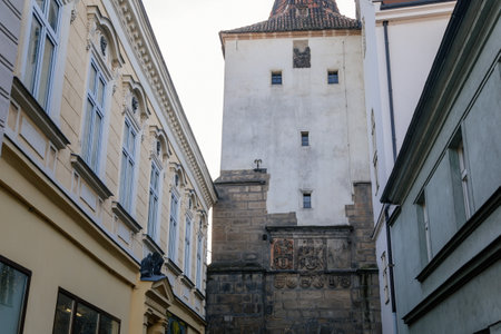 Gothic tower of the Velvary Gate, town fortifications built in the pre-Hussite period in sunny day, street of historic medieval city Slany, Central Bohemia, Czech Republic, December 27, 2020のeditorial素材