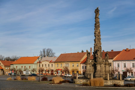 Marian Column at King Vladislav Square, Narrow picturesque street with colorful buildings in historic center of town Velvary in sunny day, Central Bohemia, Czech Republic, December 27, 2020のeditorial素材