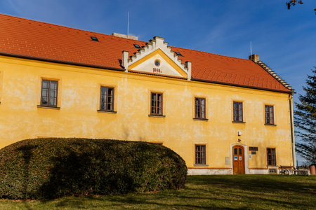 Narrow picturesque street with baroque and renaissance historical building with garden in Kladno in sunny day, Czech Republic, December 27, 2020のeditorial素材