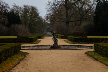 Baroque fountain near Castle Libochovice, French style park and garden in winter day, Litomerice...