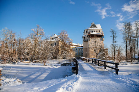Medieval renaissance water castle with half-timbered tower with snow in winter sunny day, Historic Romantic chateau Blatna near Strakonice in southern Bohemia, Czech Republic, January 09, 2021のeditorial素材